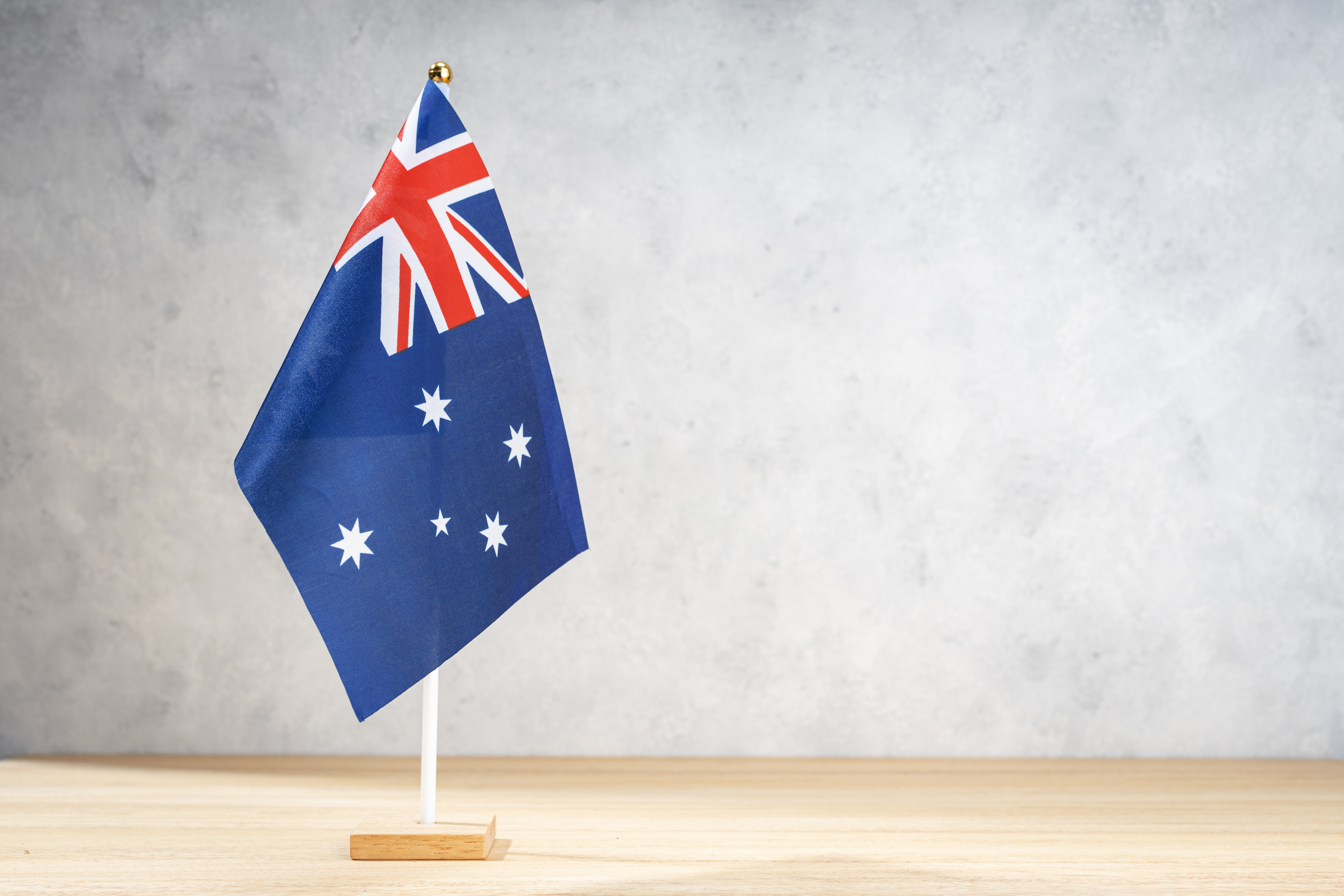 Australian table flag on white textured wall