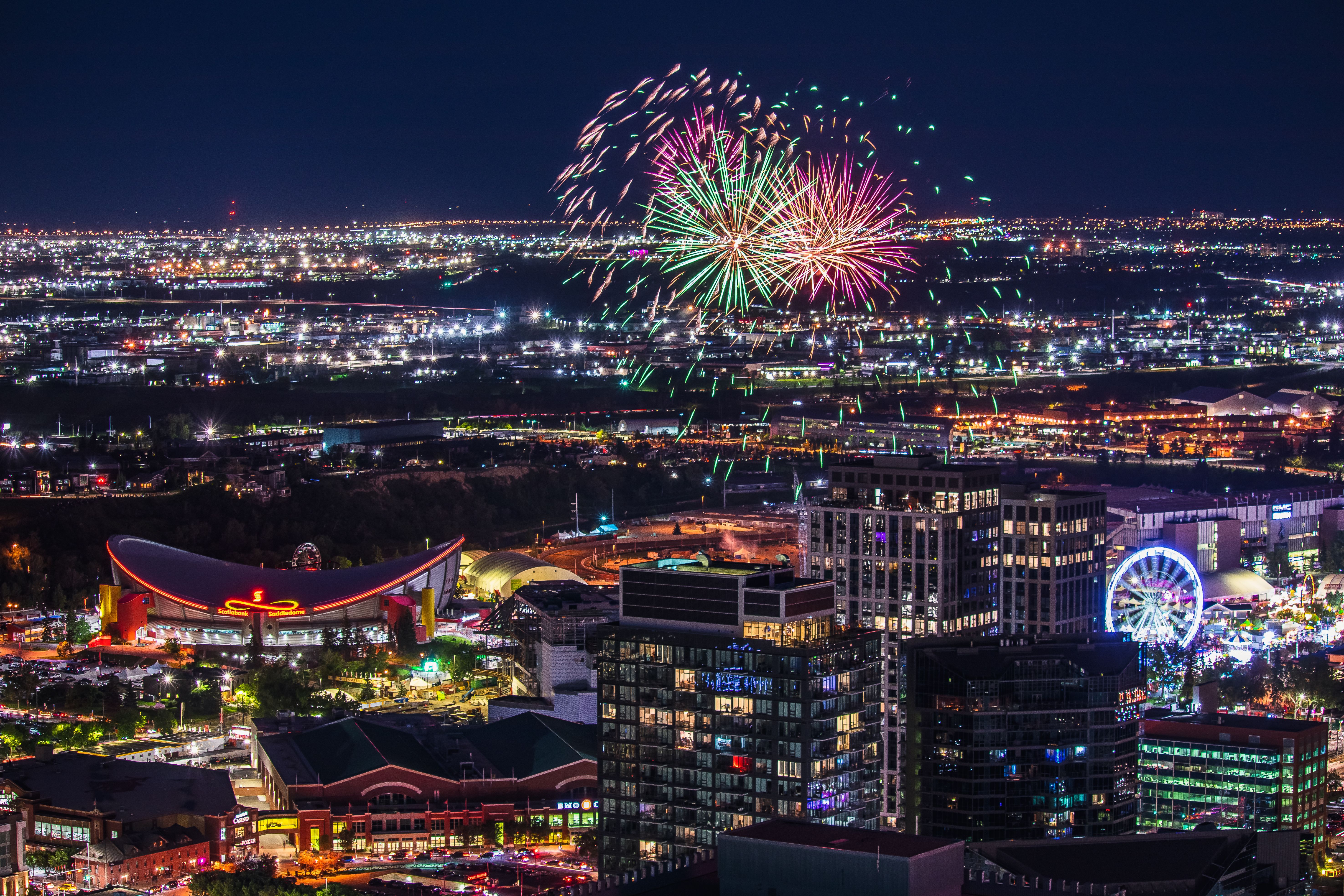 Colorful lights of the buildings and fireworks at night, Calgary, Alberta