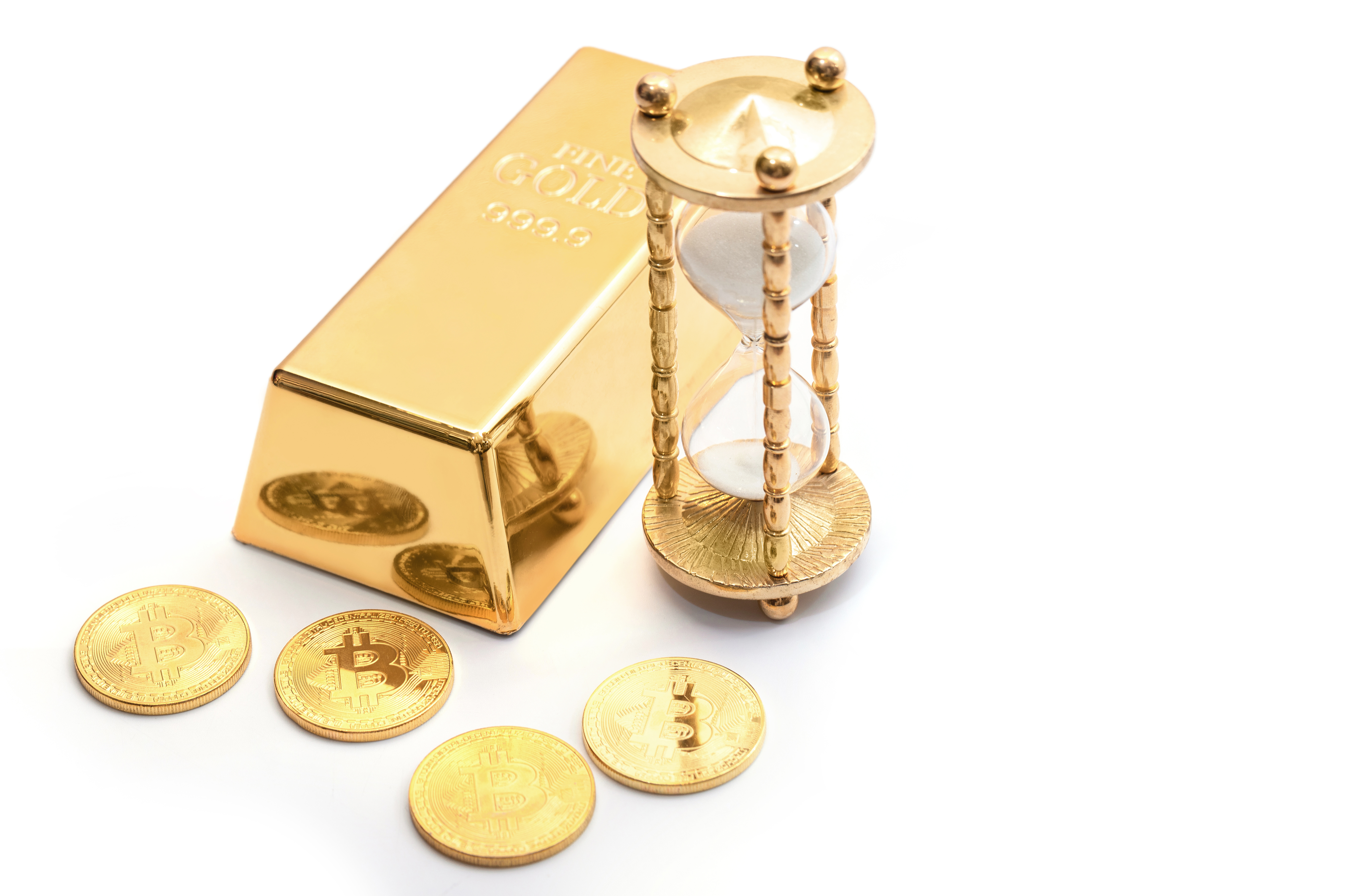 Time to invest. Gold bullion, hourglass and bitcoins.